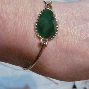 Gold tone clip on bracelet green faceted cabochon